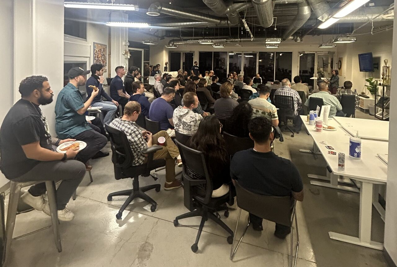 A large Rust community meetup filling a presentation room